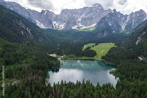 Fusine Lake in Italy with Alps mountains in background , Europe. Aerial drone view.