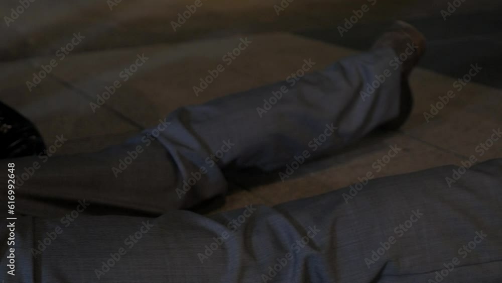 A man struggles to get free after being arrested by police on the ground at night. A man struggles to get free after being arrested by police on the ground at night.