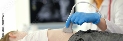 Fotografie Doctor of ultrasound diagnostics making ultrasound of liver and bile ducts to child in clinic closeup