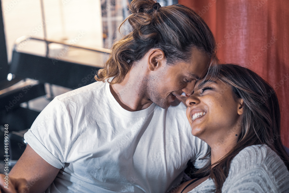 Fototapeta premium Inside house close up couple shooting sitting on sofa relaxing and smiling - Yellow and blue atmosphere tone light. Lovers shot talking in house studio red courtain