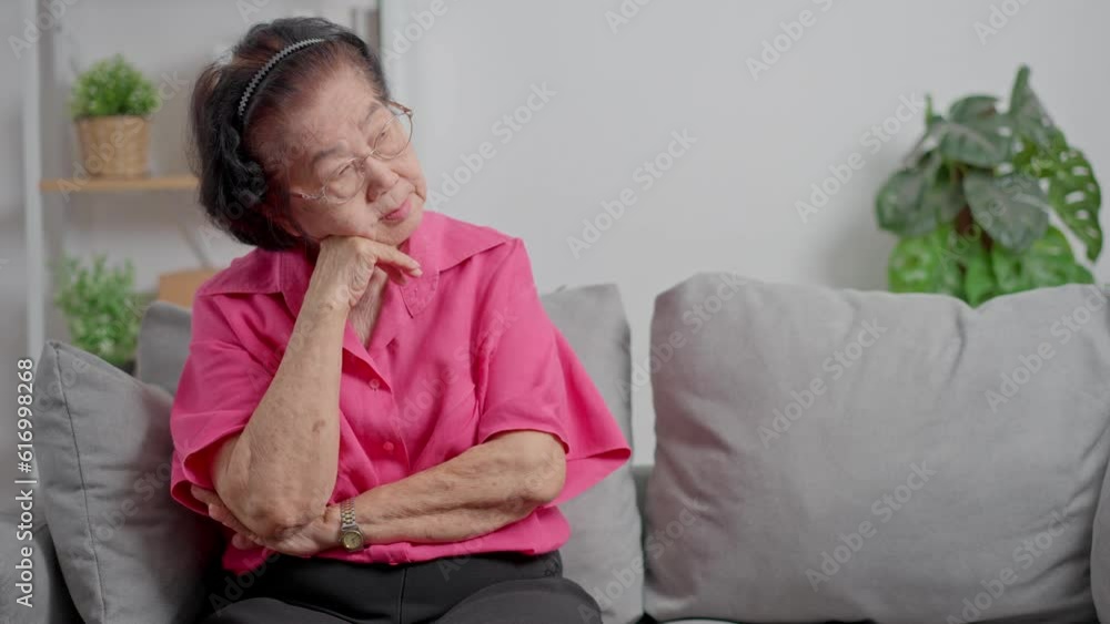 A senior woman who has a severe headache suffers from a stroke ,brain disease,patient holding head with her hand,suffering from senile dementia,memory disorders, confused old elderly with Alzheimer A senior woman who has a severe headache suffers from a stroke ,brain disease,patient holding head with her hand,suffering from senile dementia,memory disorders, confused old elderly with Alzheimer