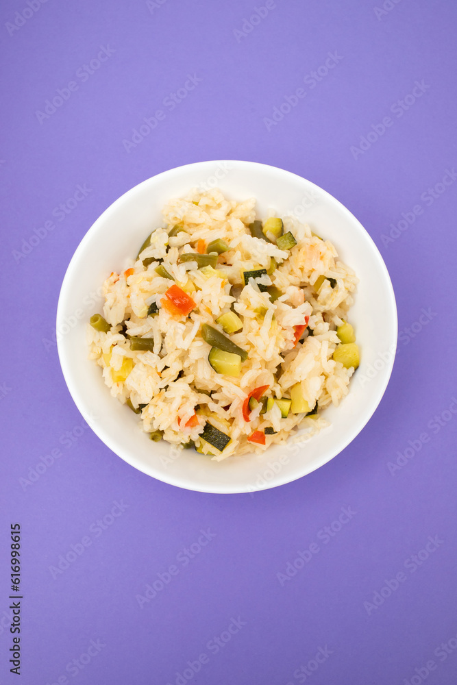 Cooked white rice mixed with colorful vegetables onion, green beans, tomato Cooked white rice mixed with colorful vegetables onion, green beans, tomato