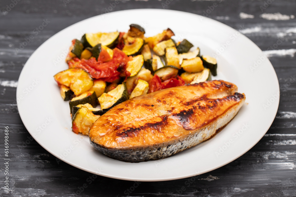 Fried salmon with vegetables on white plate Fried salmon with vegetables on white plate