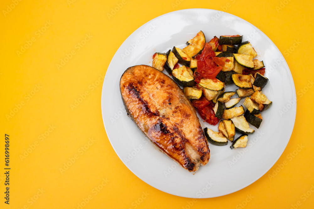 Fried salmon with vegetables on white plate Fried salmon with vegetables on white plate