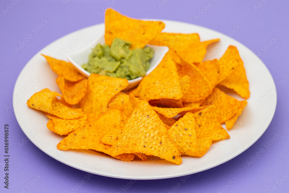 plate of corn chips nachos with guacamole on plate plate of corn chips nachos with guacamole on plate