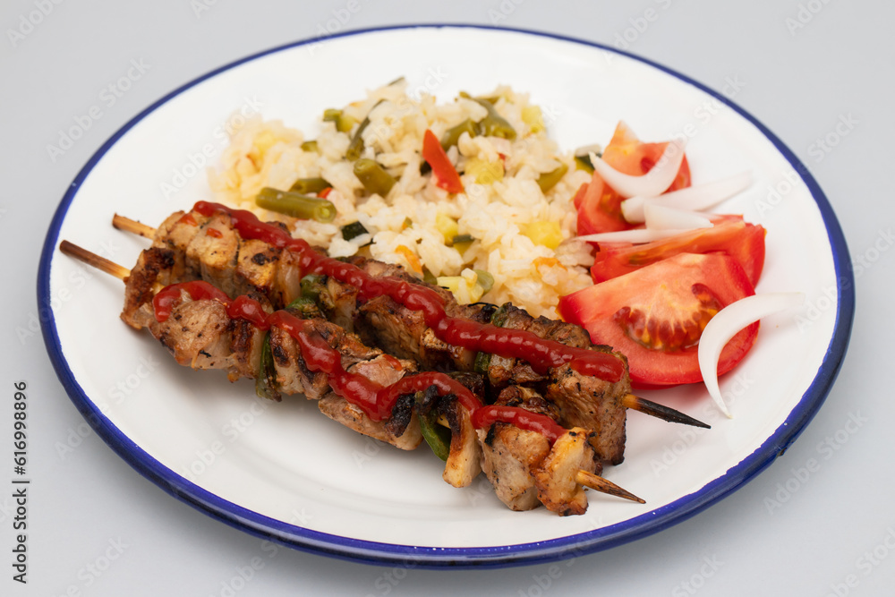 Meat and Cooked white rice mixed with colorful vegetables onion, green beans, tomato