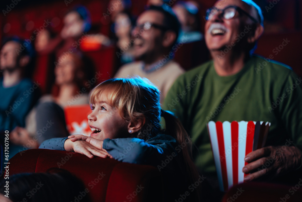 © bernardbodo - Joyful girl at movies with grandpa. © bernardbodo - Joyful girl at movies with grandpa.