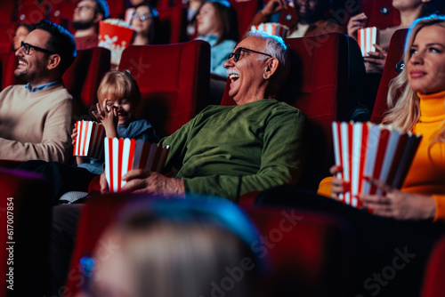 Senior man with granddaughter at movies. © bernardbodo