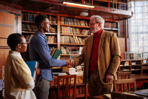 Professor congratulate students on success.