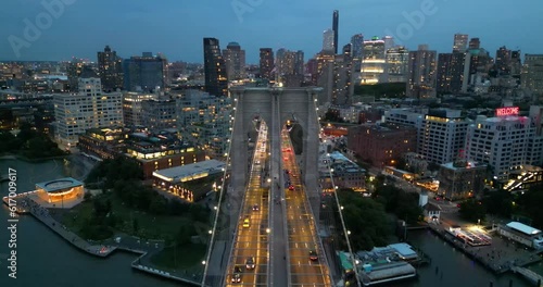 Flight over Brooklyn Bridge at dusk, New York City, USA