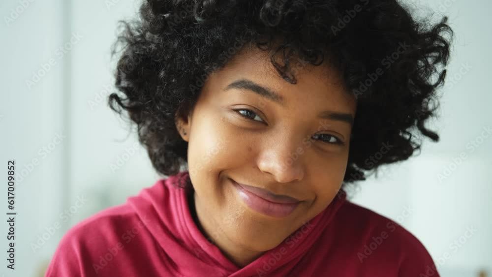 Beautiful african american girl with afro hairstyle smiling. Close up portrait of young happy girl. Young african woman with curly hair laughing. Freedom happiness carefree happy people concept Beautiful african american girl with afro hairstyle smiling. Close up portrait of young happy girl. Young african woman with curly hair laughing. Freedom happiness carefree happy people concept