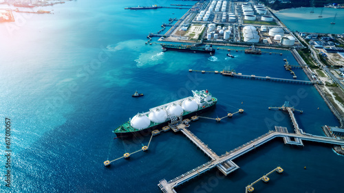 LNG (Liquified Natural Gas) tanker anchored in Gas terminal gas tanks for storage. Oil Crude Gas Tanker Ship. LPG at Tanker Bay Petroleum Chemical or Methane freighter export import transportation photo