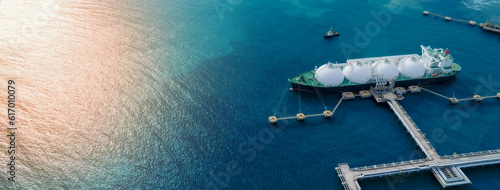 LNG (Liquified Natural Gas) tanker anchored in Gas terminal gas tanks for storage. Oil Crude Gas Tanker Ship. LPG at Tanker Bay Petroleum Chemical or Methane freighter export import transportation