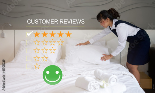 Young asian hotel maid making the bed. Show rating of service experience, evaluate quality of service leading to reputation ranking of hotel business.