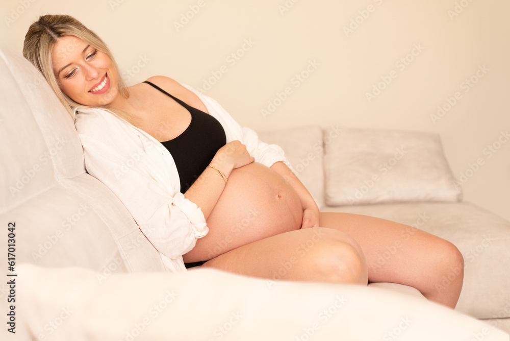 Fototapeta premium Young pregnant woman in studio lighting