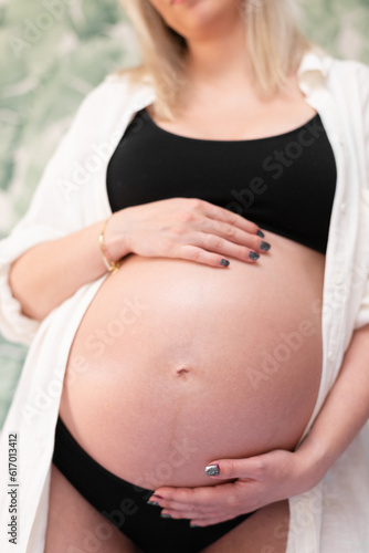 Free Download Closeup of a pregnant belly in studio lighting - GFXLoad