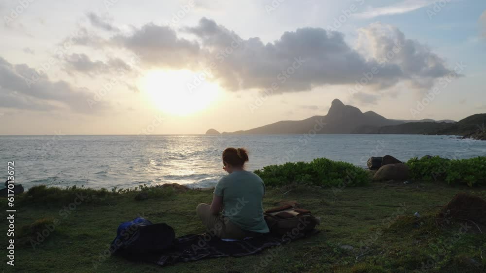 A Woman Sit And Relaxing On The Shore Of A Sunset Beach In Con Dao Island, Vietnam. A Woman Sit And Relaxing On The Shore Of A Sunset Beach In Con Dao Island, Vietnam.