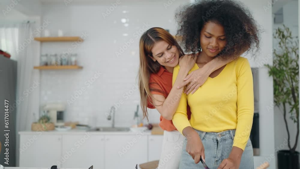 Lgbtq relationship concept. Happy lesbian lgbtq couple in love cuddling in kitchen room. Mixed race lesbian couple. Homosexual family, LGBTQ lifestyle Lgbtq relationship concept. Happy lesbian lgbtq couple in love cuddling in kitchen room. Mixed race lesbian couple. Homosexual family, LGBTQ lifestyle