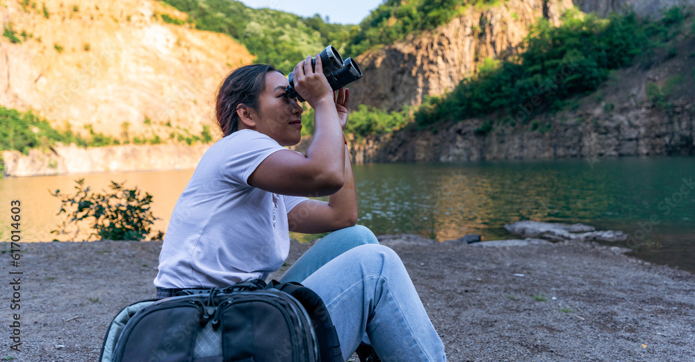 a young woman uses binoculars to better observe her surroundings and scenery a young woman uses binoculars to better observe her surroundings and scenery