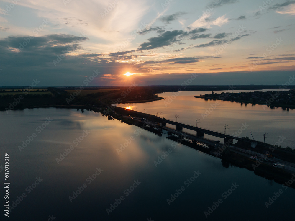 Pontoon bridge of the Ukrainian army. Installation of a temporary crossing near the destroyed bridge. Soldiers collect pontoon ferry. Top view from a drone. Nikopol, UKRAINE – May 26, 2020