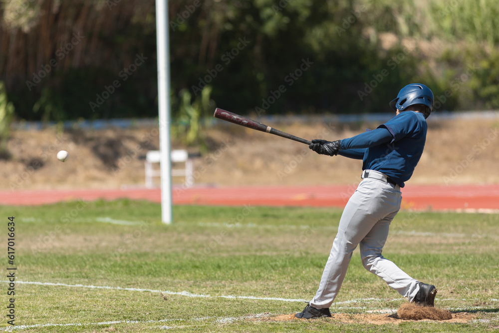 Baseball game - the batter in blue uniform about to hit the ball