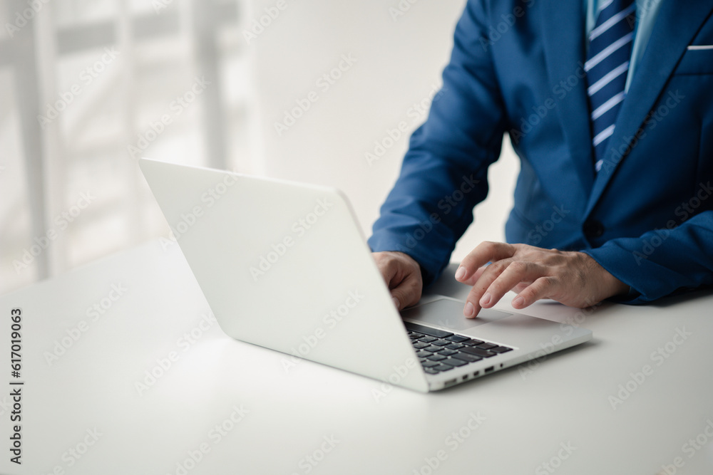 Person typing on laptop keyboard, businessman working on laptop, he is typing messages to colleagues and making financial information sheet to sum up the meeting. Person typing on laptop keyboard, businessman working on laptop, he is typing messages to colleagues and making financial information sheet to sum up the meeting.
