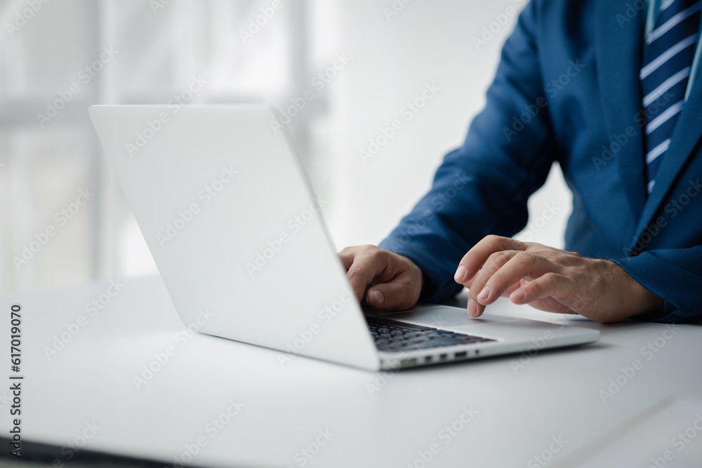 Person typing on laptop keyboard, businessman working on laptop, he is typing messages to colleagues and making financial information sheet to sum up the meeting. Person typing on laptop keyboard, businessman working on laptop, he is typing messages to colleagues and making financial information sheet to sum up the meeting.