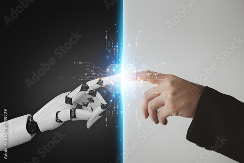 Photography Robot and human hands pointing to each other, the idea of creating futuristic AI, intelligent systems to work instead of humans and do what humans can't
