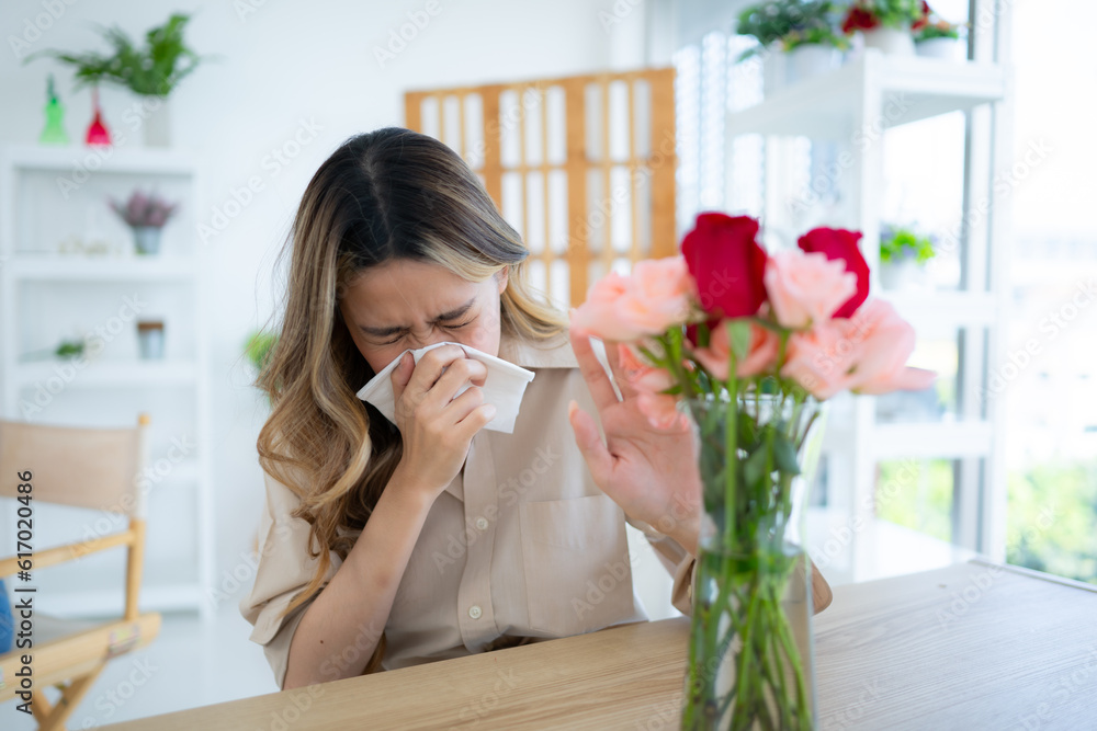 Woman sneezing in tissue due to allergy to pollen Woman sneezing in tissue due to allergy to pollen