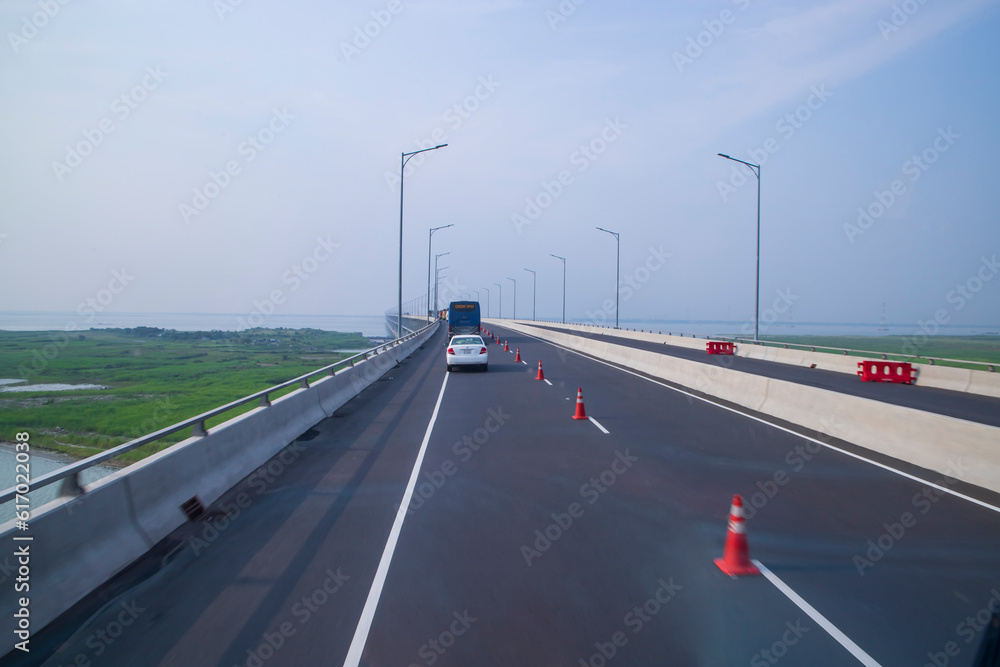 Fototapeta premium Padma Bridg Highway asphalt with blue sky Background. Perspective view