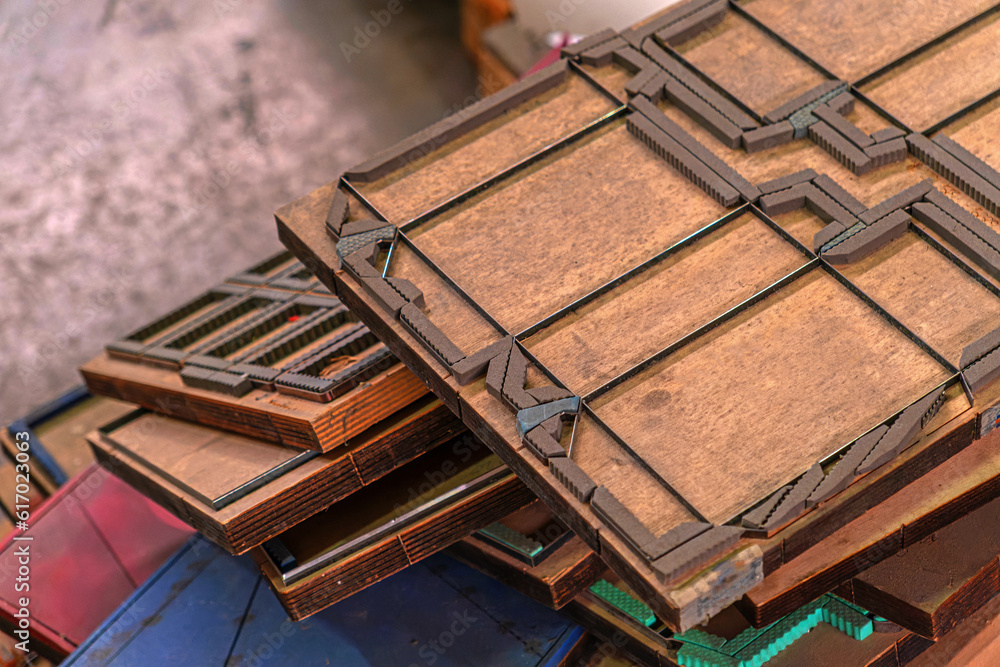 Old paper cutting molds Old Dye punching paper mold template in wood. Packaging production die cutting mold. Old paper cutting molds Old Dye punching paper mold template in wood. Packaging production die cutting mold.