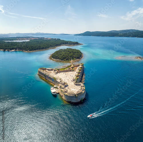 Fototapeta Naklejka Na Ścianę i Meble -  Aerial view of the fortress of St. Nicholas and the many islands in the waters of the picturesque town of Shibenik on the Adriatic coast of Croatia.