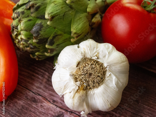 Close up, macro. Artichoke, garlic, tomato. Fresh vegetables. Produce. Healthy eating. 