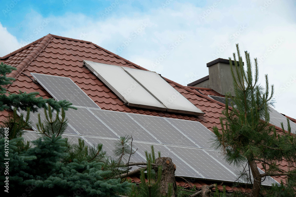 Installing a Solar Cell on a Roof. Solar panels on roof. Historic farm house with modern solar panels on roof and wall. High quality photo Installing a Solar Cell on a Roof. Solar panels on roof. Historic farm house with modern solar panels on roof and wall. High quality photo