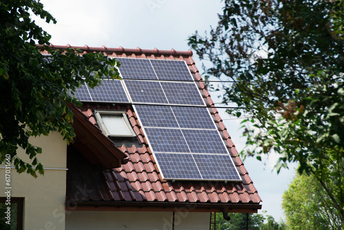 Installing a Solar Cell on a Roof. Solar panels on roof. Historic farm house with modern solar panels on roof and wall. High quality photo