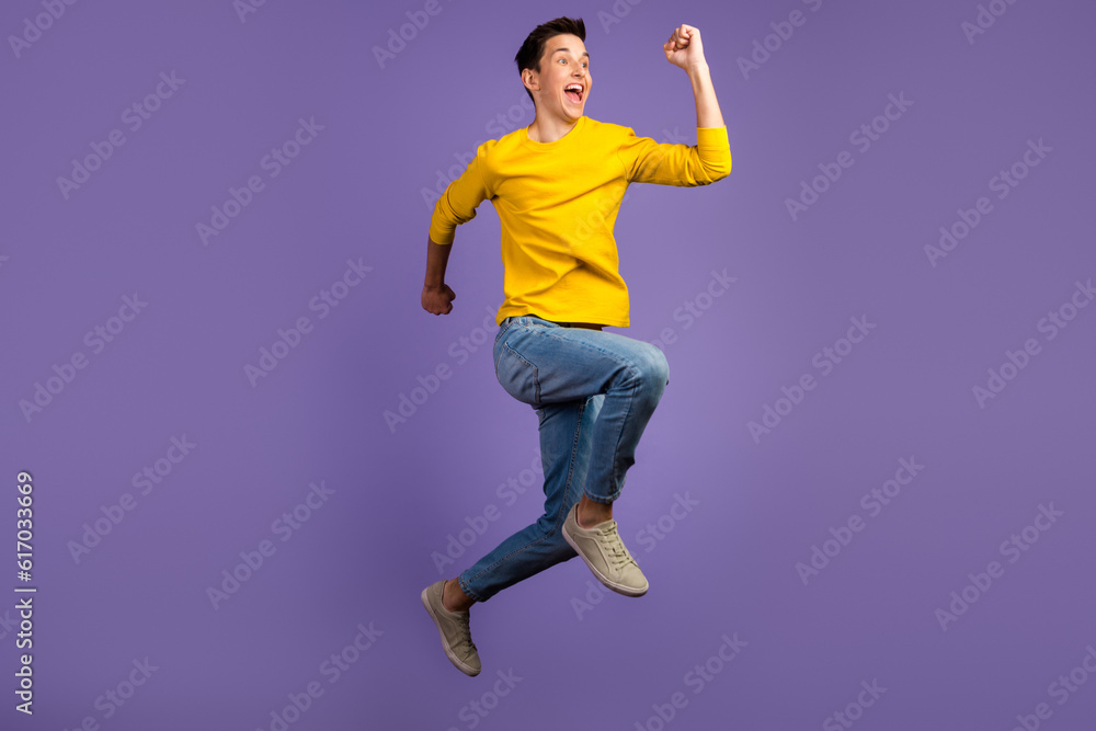 Full-length portrait of crazy excited handsome man jumping up runner fast sale isolated on shine background Full-length portrait of crazy excited handsome man jumping up runner fast sale isolated on shine background
