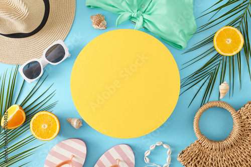 The concept of a summer retreat. Top view photo of flip flops, hat, eyewear, orange, palm leaves, swimsuit, handbag, shell bracelet, seashell on pastel blue background with blank circle for advert