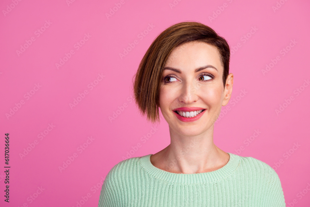Pretty smiling joyfully female with fair hair dressed casually looking with satisfaction at camera isolated against blank studio wall Pretty smiling joyfully female with fair hair dressed casually looking with satisfaction at camera isolated against blank studio wall