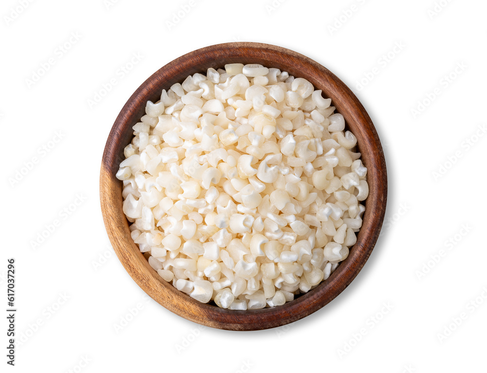 Dried canjica, hominy or white corn on a bowl isolated over white background Dried canjica, hominy or white corn on a bowl isolated over white background