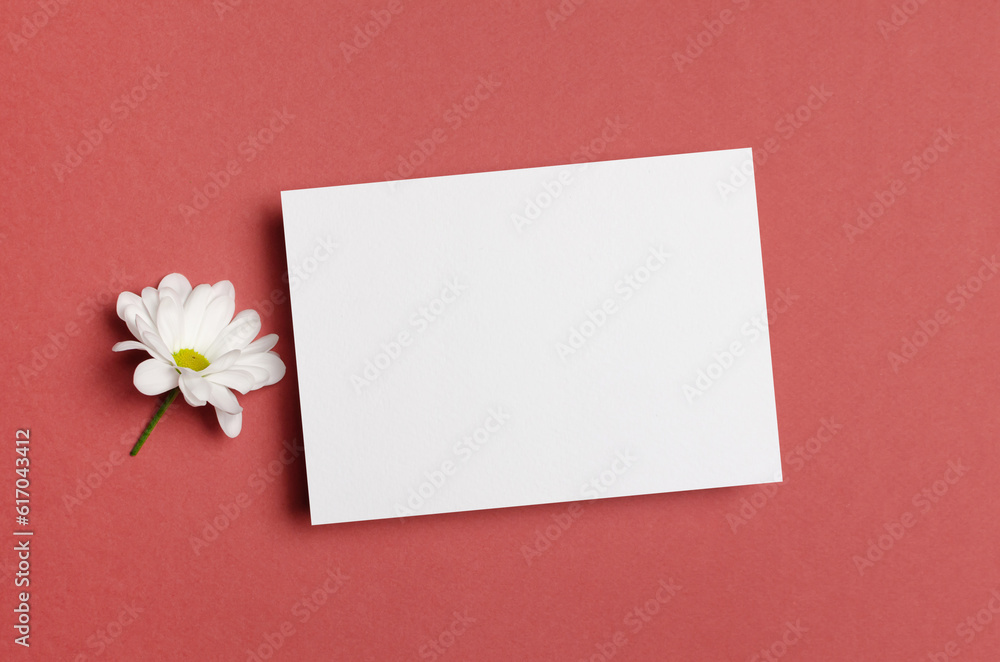 Blank paper card mockup with white flower, invitation or greeting card mock up with copy space Blank paper card mockup with white flower, invitation or greeting card mock up with copy space