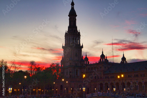 Night view of the monument of plaza de spain in seville, spain. Reddish sky at sunset in the city.