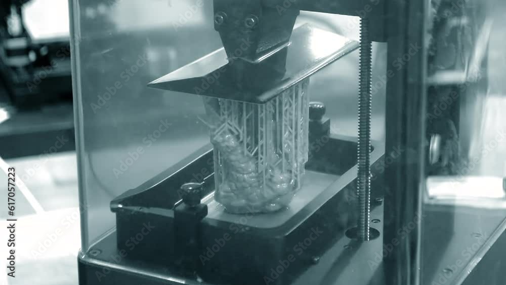 Working of photopolymer sla 3D printer. Platform with building object