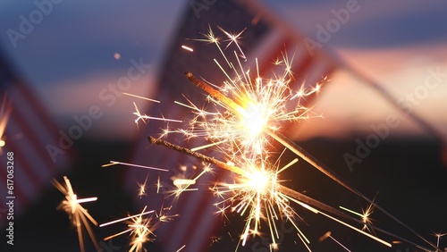 Fireworks sparklers fourth of July  Happy USA Independence Day Holiday  Celebration. Hands Holding Sparklers Fireworks with USA American Flag at sunset outdoor background. Concept 4th of July  Freedom