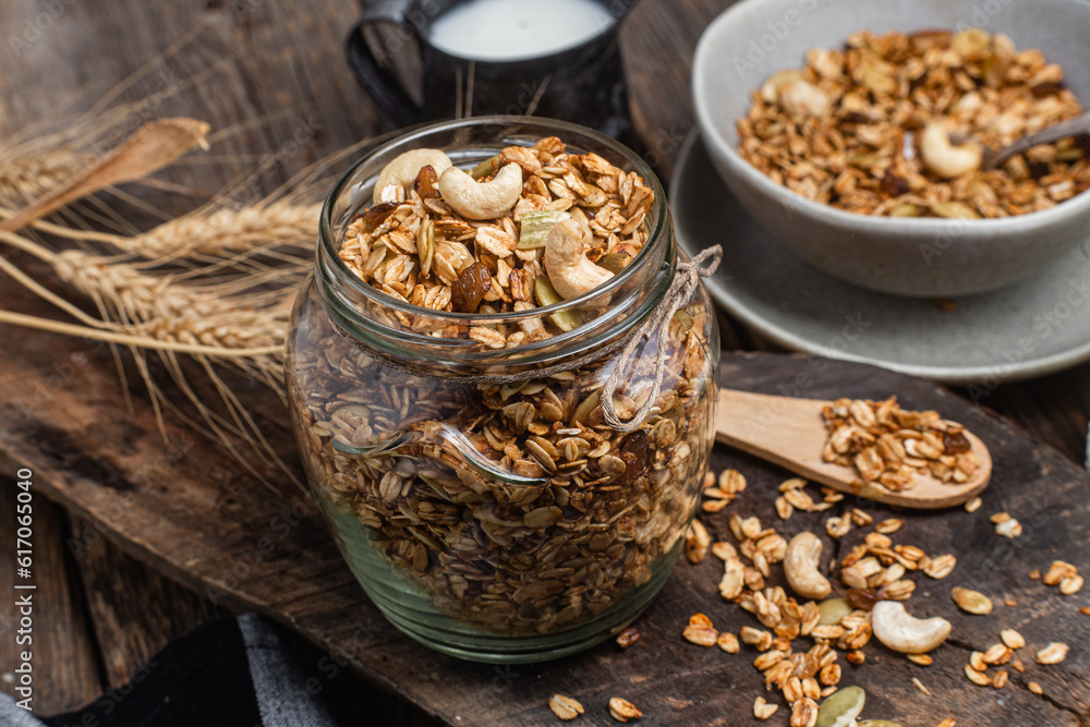 Granola with nuts, raisins and pumpkin seeds in a glass jar Granola with nuts, raisins and pumpkin seeds in a glass jar