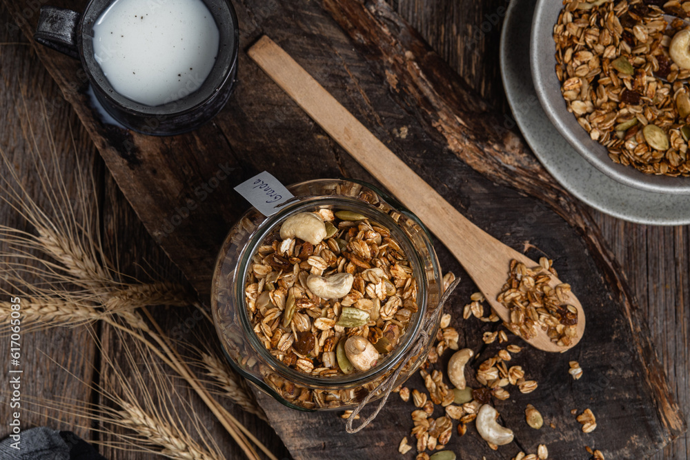 Granola with nuts, raisins and pumpkin seeds in a glass jar Granola with nuts, raisins and pumpkin seeds in a glass jar