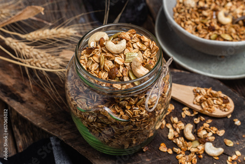 Granola with nuts, raisins and pumpkin seeds in a glass jar