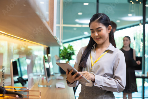 business female worker working on laptop computer. Portrait confident asian women smiling looking at camera at modern smallbusiness home office