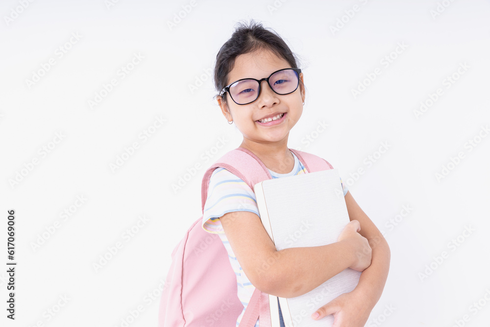 Asia kids girl smile happiness wearing glasses with a pink backpack learn at school isolated on white background with copy space. Concepts back to school, learning, education. Asia kids girl smile happiness wearing glasses with a pink backpack learn at school isolated on white background with copy space. Concepts back to school, learning, education.