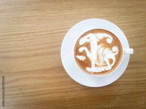 Artistic Latte Coffee: White Cup on Wooden Table with Camel Shape