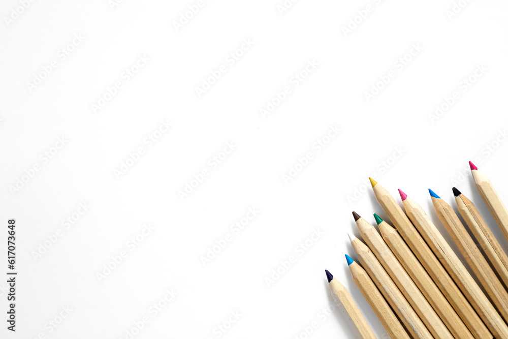 Obraz premium Wooden multi-colored pencils on a white background, isolated, top view.